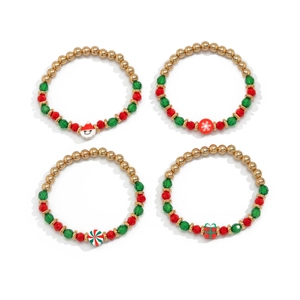 Close-up of four Christmas beaded bracelets with Santa, snowflake, and gift box charms