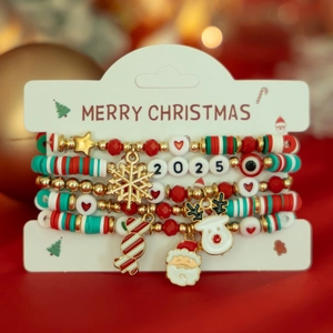 Detail of Christmas beaded bracelet set with snowflake and Santa charms on gift card