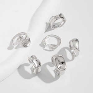 Set of six irregular silver metal rings with a liquid metallic aesthetic and minimalist design