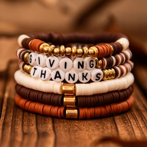 Macro shot of colorful polymer clay beads with GIVING THANKS acrylic letter charms