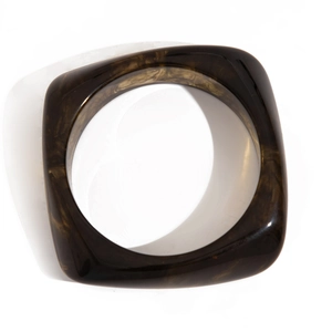 Top view of wide acrylic bangle featuring retro tortoise shell pattern and geometric design
