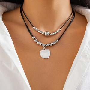 Double-layered black cord necklace with silver beads and smooth round metal pendant