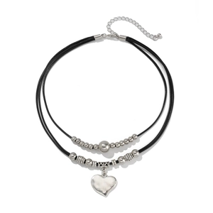 Detail of double-layer choker with heart pendant, wax cord, and bohemian silver beads