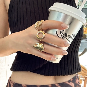 Three-piece gold chunky ring set featuring twisted knot and irregular shield designs