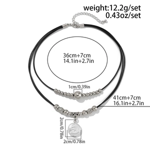 Detail showing dimensions of a layered black cord necklace with silver beads and pendant