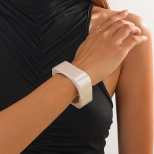 Detail of silver geometric square bracelet with brushed metal finish on female wrist