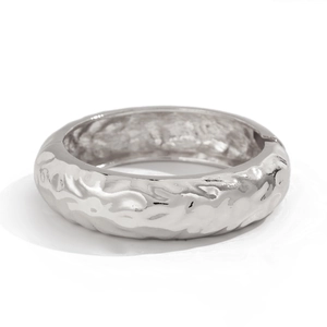 Macro shot of liquid metal bangle with hammered texture and side hinge closure details