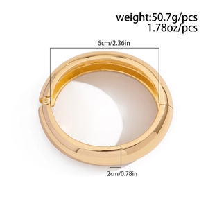 Detail view of bold chunky golden bangle showing 6cm inner diameter and 2cm width