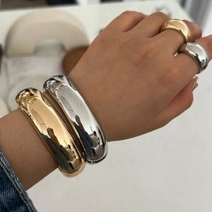Minimalist thick curved metal bracelet and ring set in polished gold and silver finishes