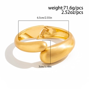 Detail showing matte gold spring hinge bracelet dimensions and brushed metal texture