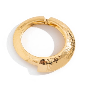 Golden hammered metal cuff bracelet with spring hinge closure and irregular texture finish