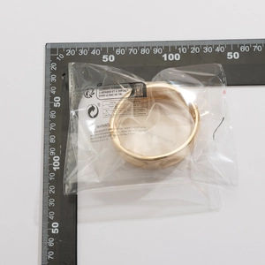Detailed size measurement of a gold waterdrop bangle showing 70mm diameter in packaging