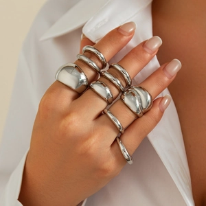 Close-up of minimalist silver stacked rings set with polished metallic finish