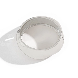 Minimalist wide silver cuff bracelet with mirror finish and hinge closure on white