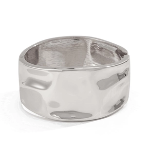Macro detail of silver liquid metal wide cuff bracelet with wavy texture and side hinge