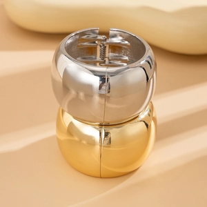 Detail of wide metal hair cuffs in gold and silver with spring hinge mechanism