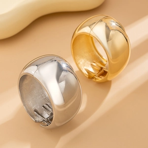 Detailed view of gold and silver metallic ponytail cuffs with spring clip mechanism