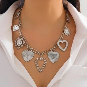 Detail shot of multi-heart pendant necklace with striped metal chain links for women