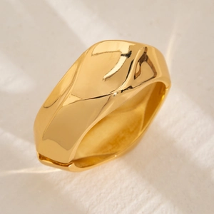 Minimalist gold-tone wide alloy bangle with irregular wavy texture and polished mirror finish