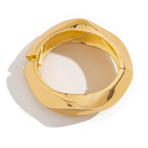 Minimalist wide irregular gold alloy bracelet with a polished finish and hinged closure