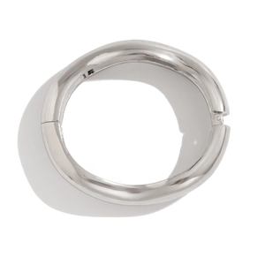 Macro view showing the polished asymmetrical metal surface and hinge of the silver wide bracelet