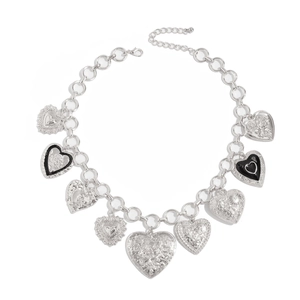Detail of silver link necklace with nine various gothic heart pendants and floral relief
