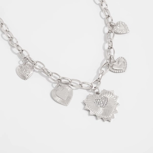 Detailed silver chain necklace with five distinct heart pendants and textured engravings