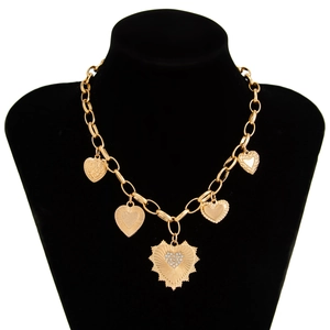Macro detail of gold chunky chain necklace featuring five assorted heart-shaped pendants
