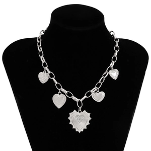 Detailed view of silver chunky chain necklace with five textured heart pendants and crystals