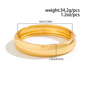 Polished gold cuff bracelet detail with dimensions 6cm diameter and 1.2cm width