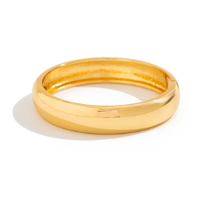Detailed view of golden polished bangle with a hinge clasp on a clean white background