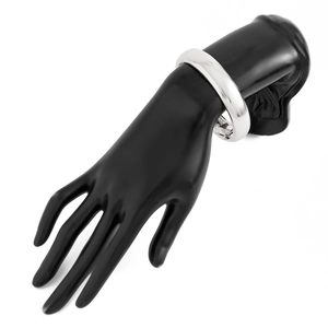 Close-up of polished silver spring bracelet on a black hand model with a sleek mirror finish