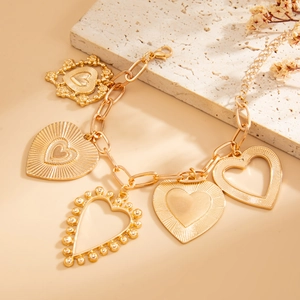Close-up of gold multi-heart pendant bracelet with striped chain and lobster clasp