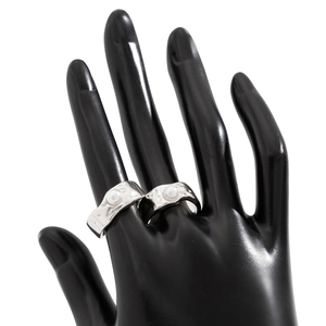 Detailed close-up of silver lava texture rings with pearls on a display model