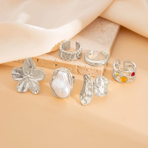 Detailed set of six vintage silver rings featuring baroque pearls and floral lava motifs