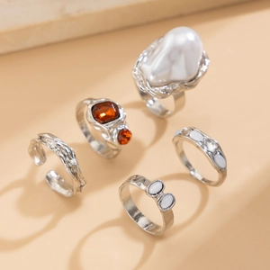 Detail of 5-piece silver ring set with baroque pearl and lava texture design