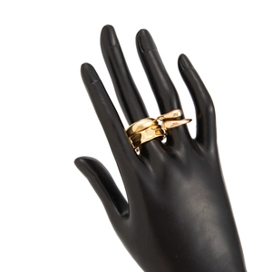 Close-up of golden geometric ring set with teardrop detail on a hand display