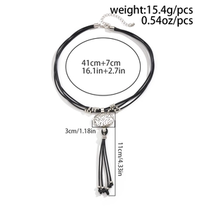 Detail showing dimensions of ethnic necklace with silver oval pendant and black tassel