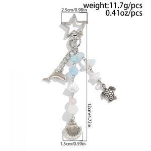 Detailed view of 12cm ocean theme keychain with dolphin turtle pendants and blue beads