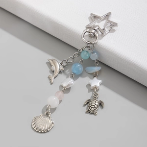 Détails du porte-clés océan argenté avec dauphin, tortue, coquillage et perles bleues