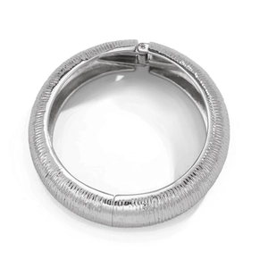 Macro shot of silver textured bangle showing vertical stripes and hinge detail