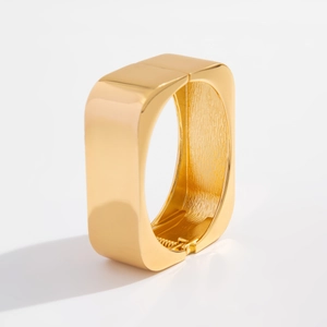 Detailed close-up of a gold square spring hinge bracelet with a mirror-finish surface