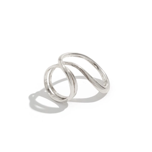 Detailopname van de zilveren druppelarmband met gepolijste afwerking en gekruist design