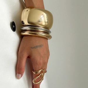 Chunky irregular metal bracelet set with polished gold and silver stackable bangles