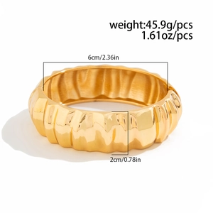 Gold chunky ribbed cuff bracelet with minimalist pleated texture and hollow spring design