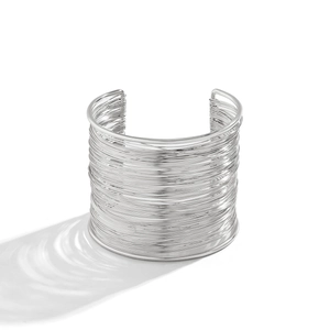 Macro detail of silver layered wire cuff bracelet with caustic light reflections