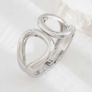 Polished silver metal cuff bracelet with hollowed double circle design and side hinge