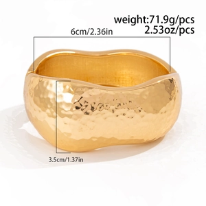 Macro view of gold hammered cuff bracelet showing dimensions of 6cm diameter and 3.5cm width