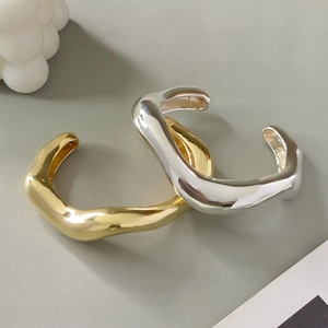 Minimalistische brede geometrische metalen armbanden met onregelmatige rondingen in goud en zilver