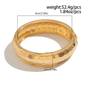 Detail view of gold geometric cuff bracelet with hammered texture and 2cm width dimension